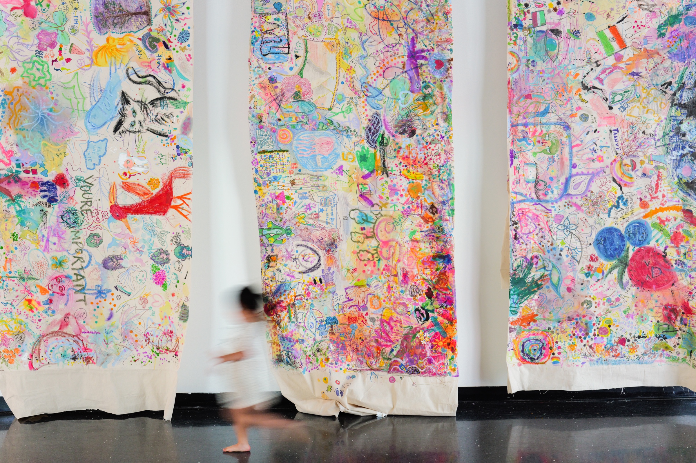 The three completed collaborative canvases displayed side by side at Bellevue Arts Museum.